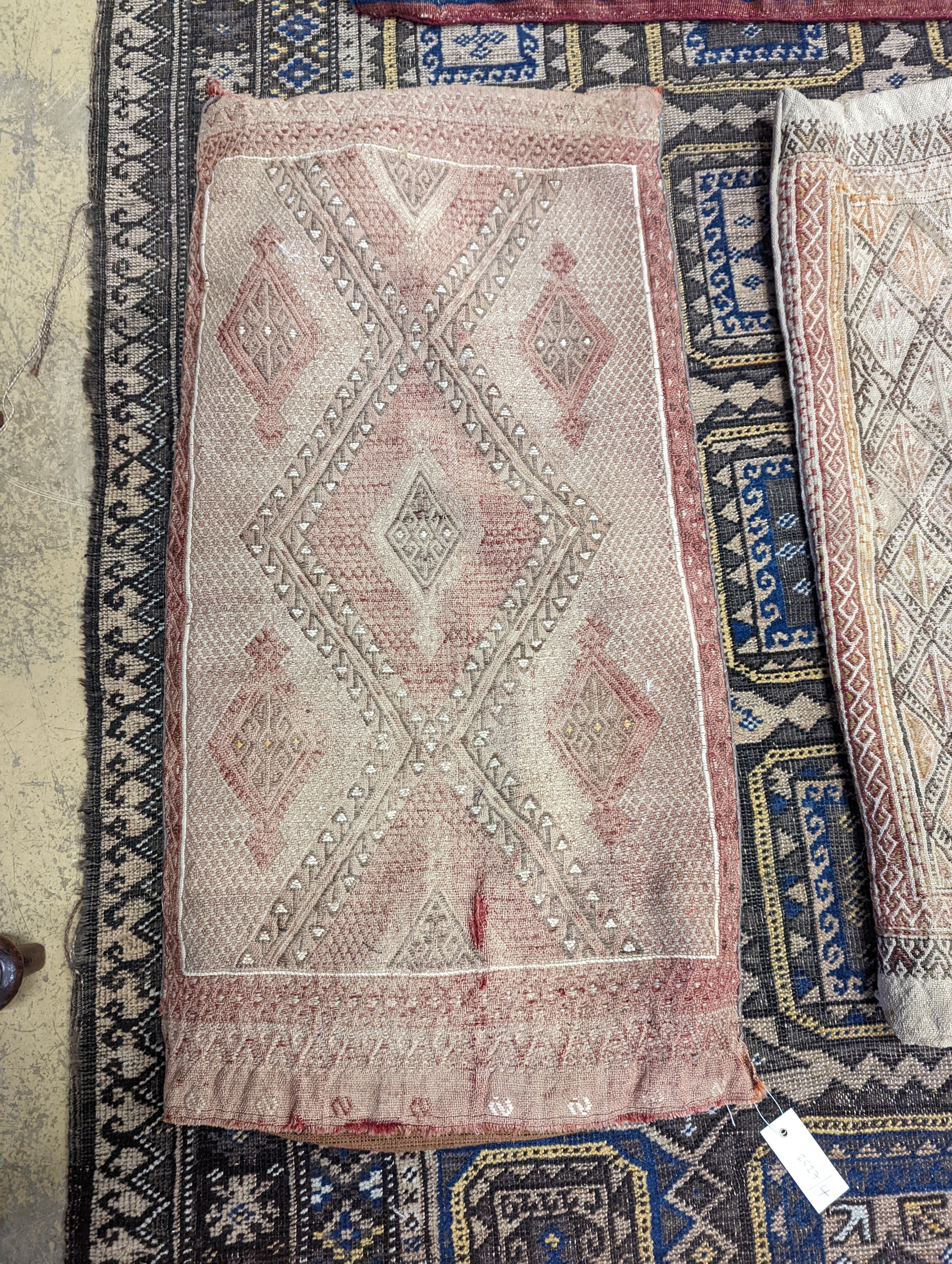 A Belouch geometric rug, 216 x 130cm. together with four Kelim cushion covers